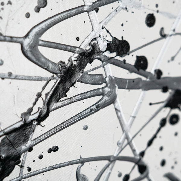 Full view of abstract black and white painting on unstretched canvas